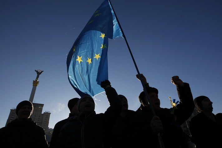 Protesters wave flags on Independence Square in Kiev.