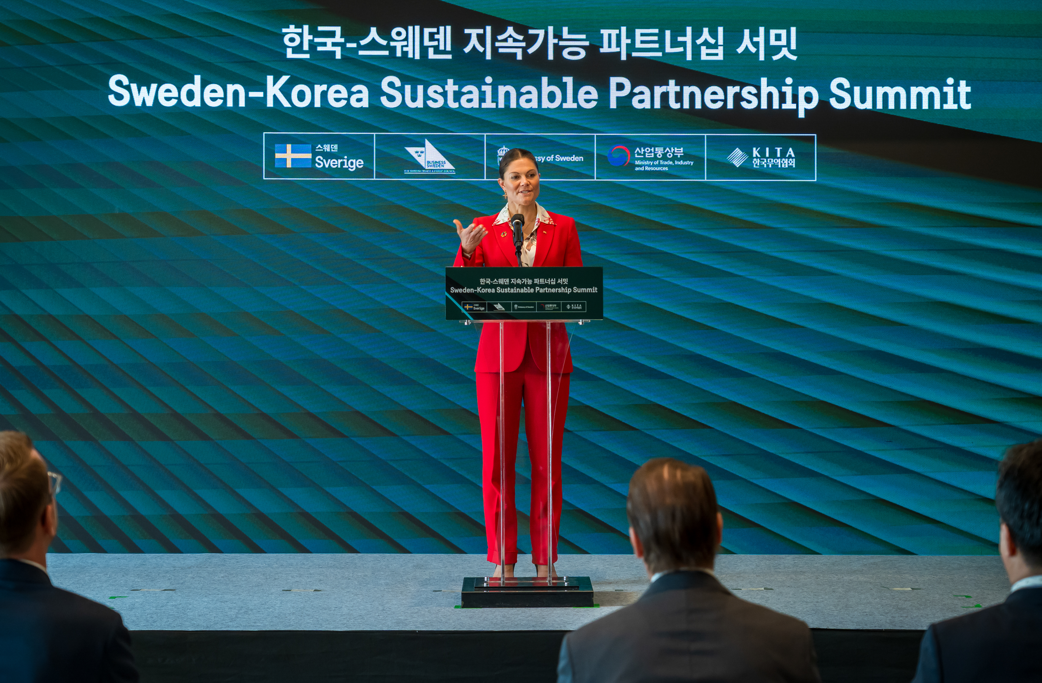 Crown Princess Victoria speaking at podium. 