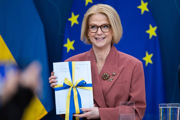 A woman with a gift wrapped book.