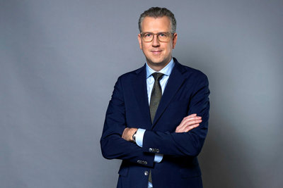 Half-length portrait of Tobias Karlström against a grey background.