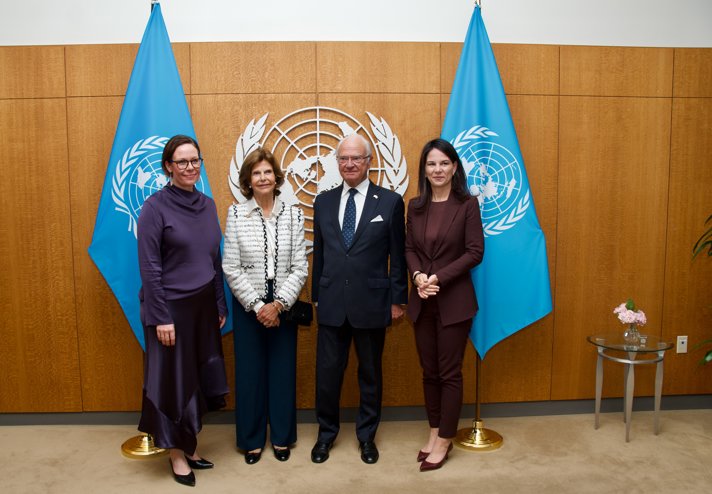 Minister for Foreign Affairs Maria Malmer Stenergard, His Majesty The King and Her Majesty The Queen and President of the United Nations General Assembly Annalena Baerbock in front of the UN symbol and flags..